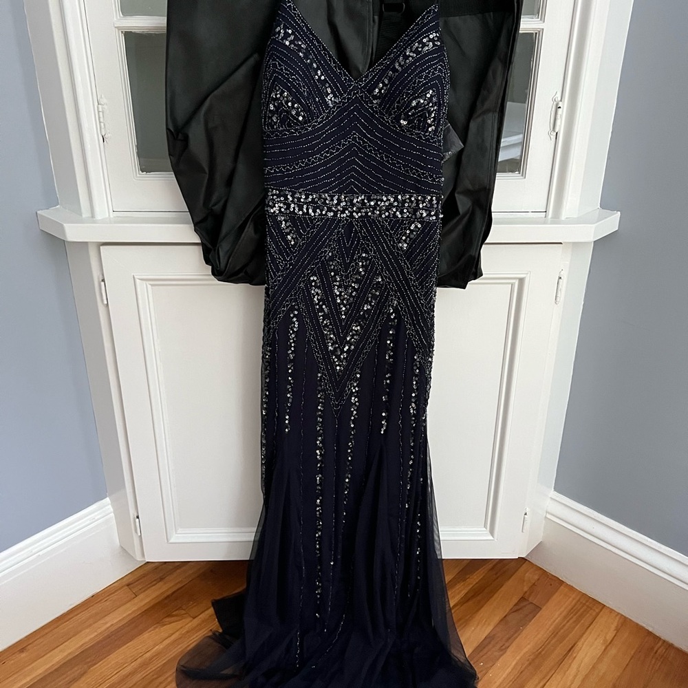 Marina Gown from Bloomingdales. Size 12. Never worn. Beaded and mermaid tail hem